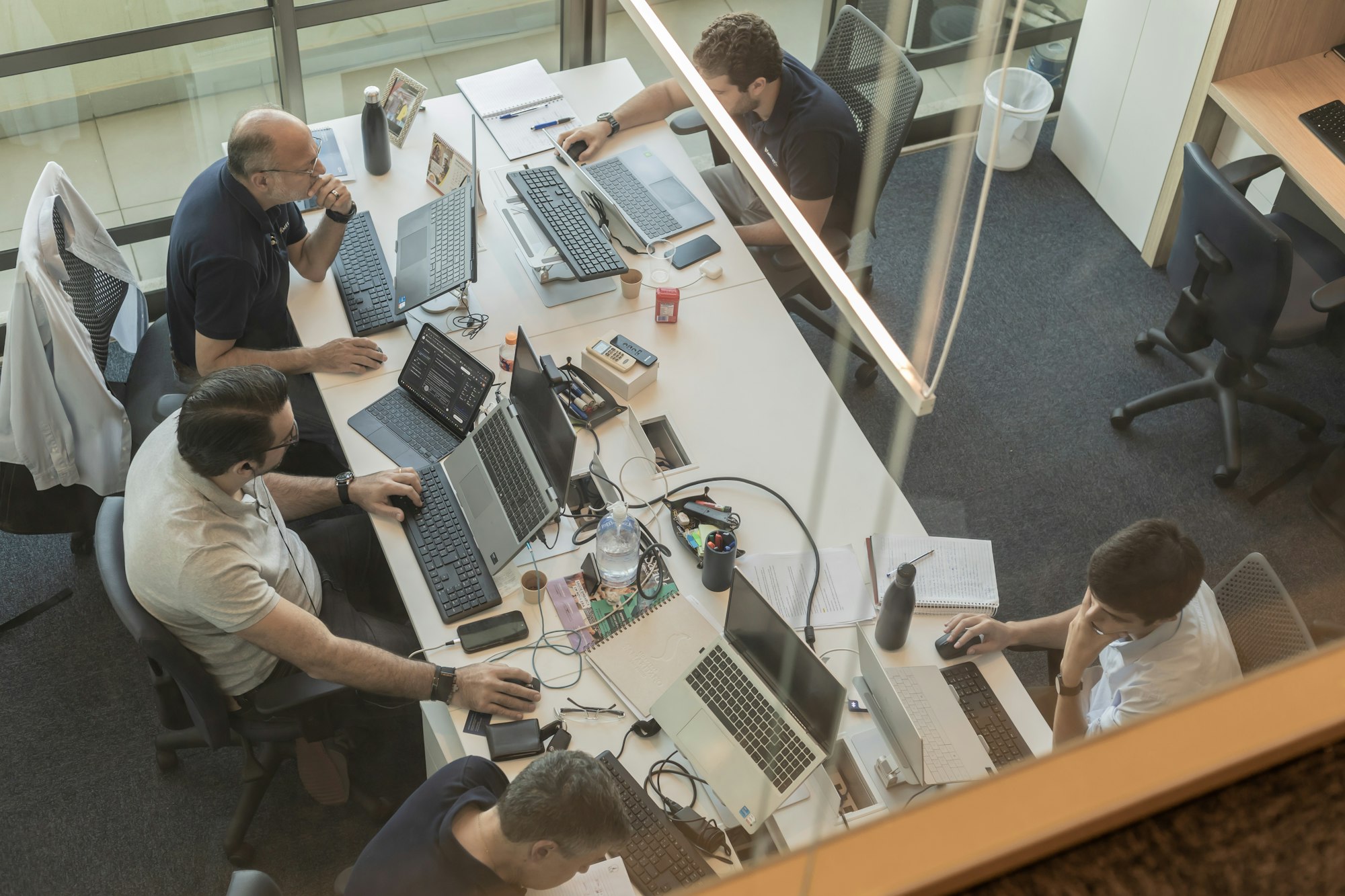 Overhead view of an office team collaborating around a shared desk