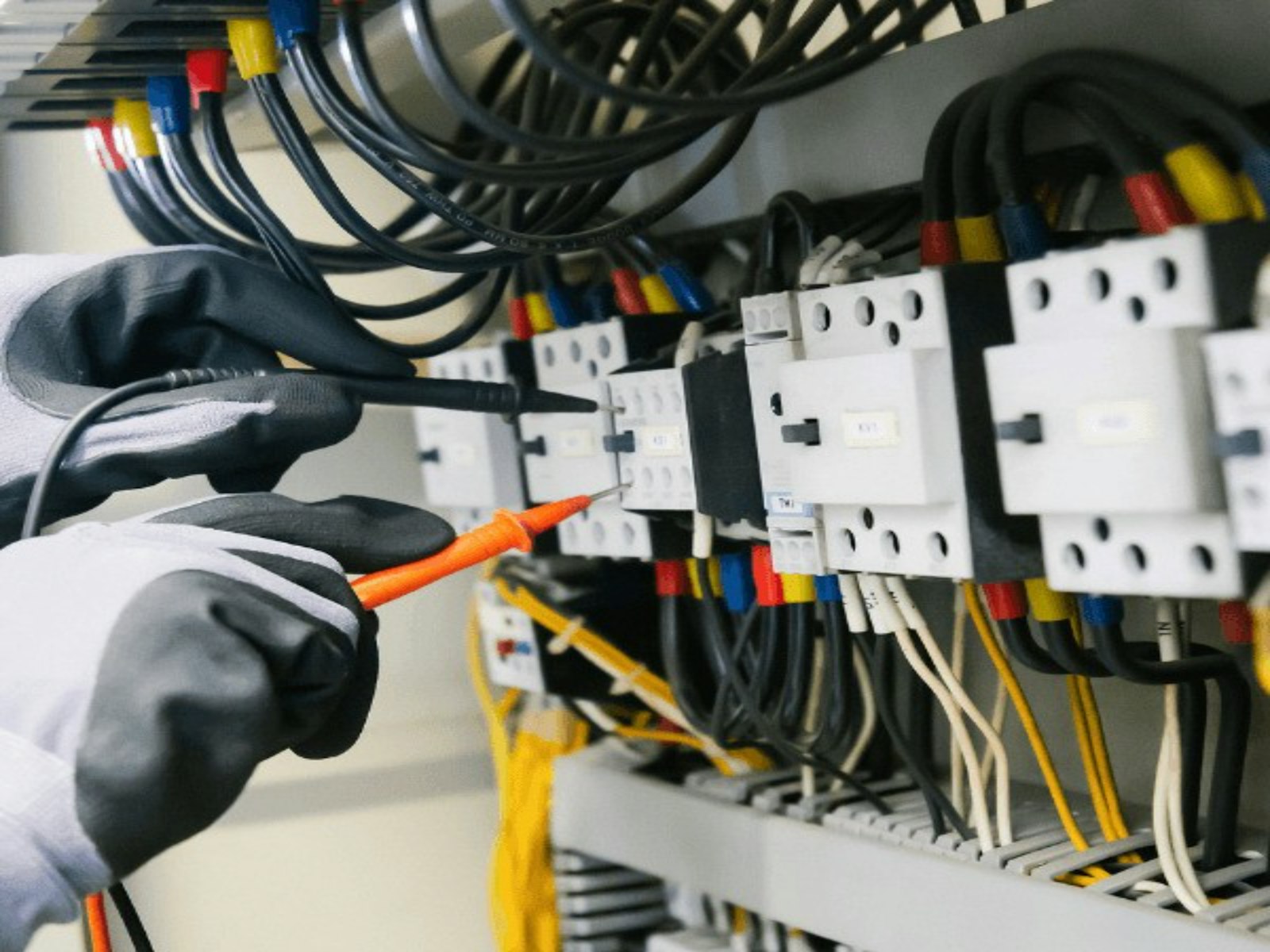 Electrician testing a commercial switchboard